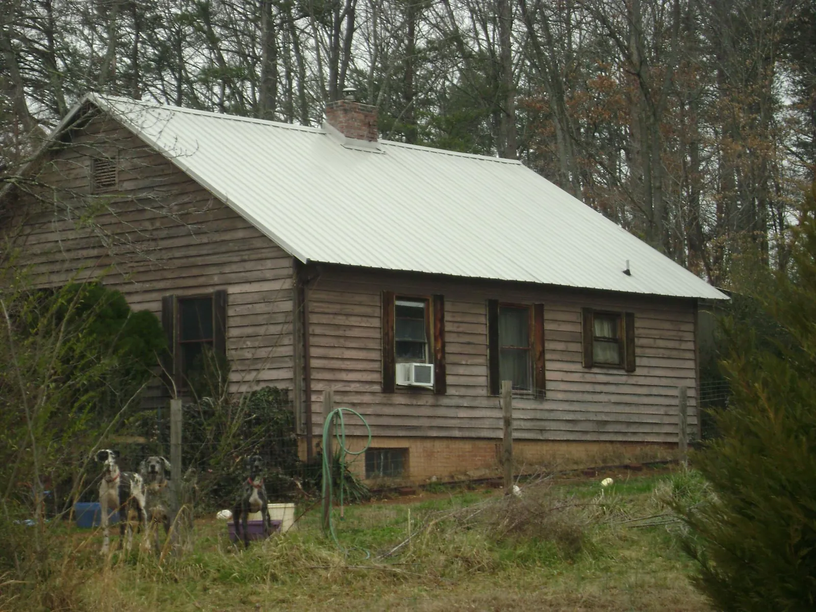White metal roof on an old wood sided farmhouse, from a Metal Roof Installation job in Ansonville